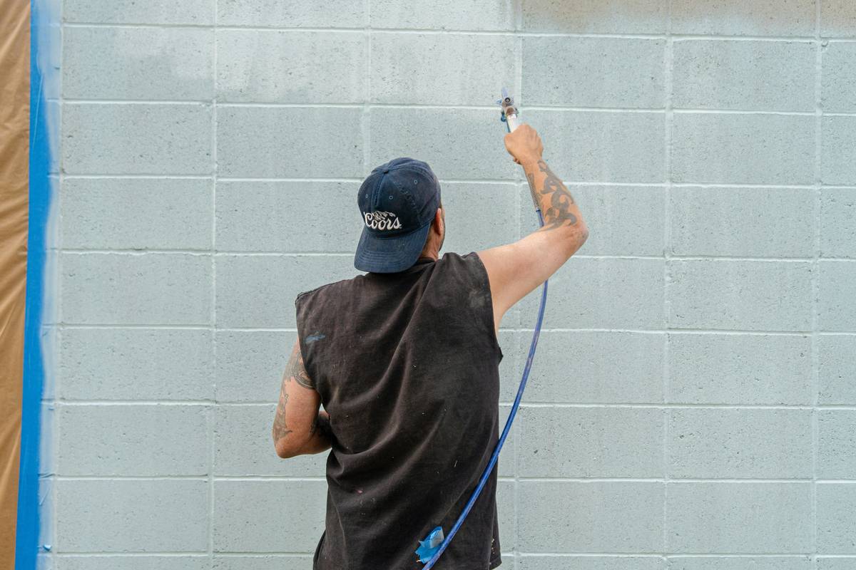 Professional using caulk gun construction on steel framing joint