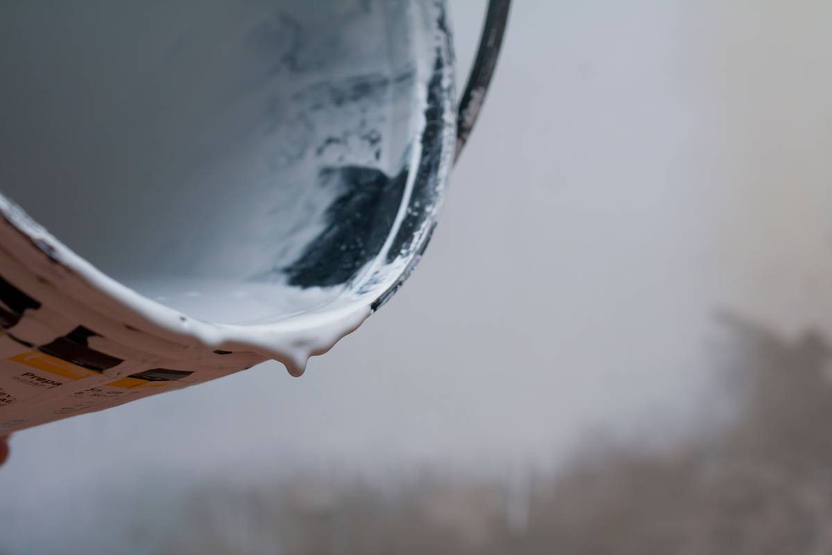 Heavy duty caulking gun in action applying sealant to a construction joint