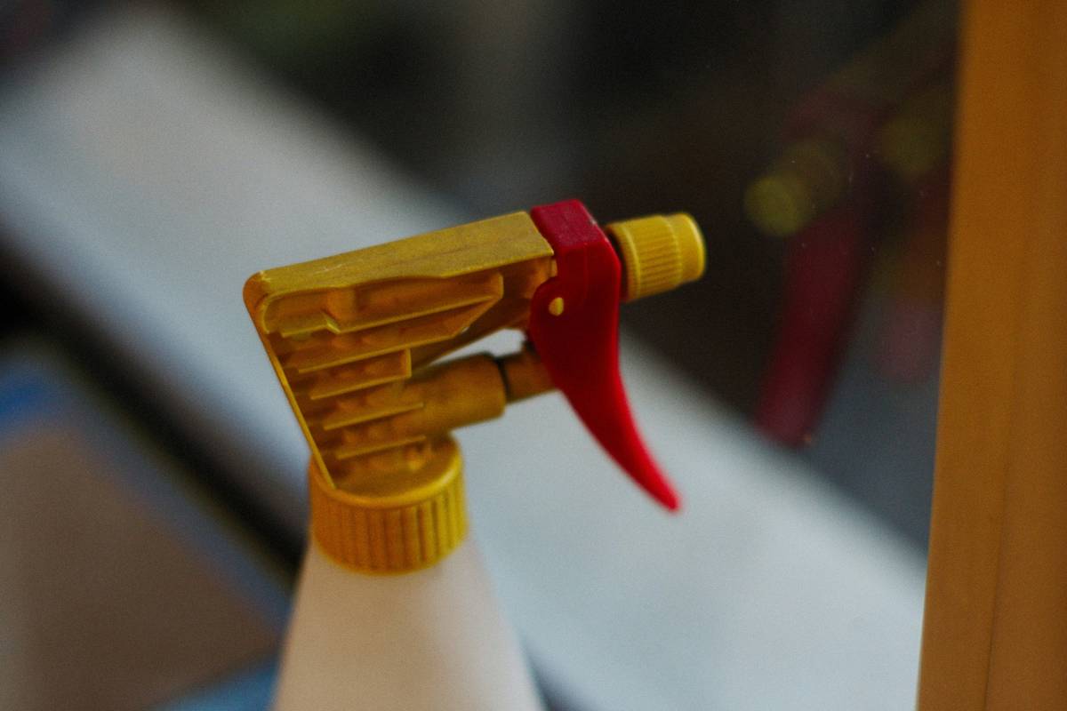 Professional using a heavy duty sealant applicator gun to apply silicone around a bathroom fixture